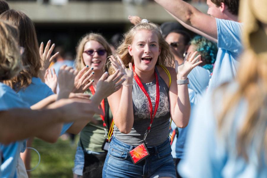 Incoming freshman run through a tunnel of DIS leaders during the Destination Iowa State Kickoff event.