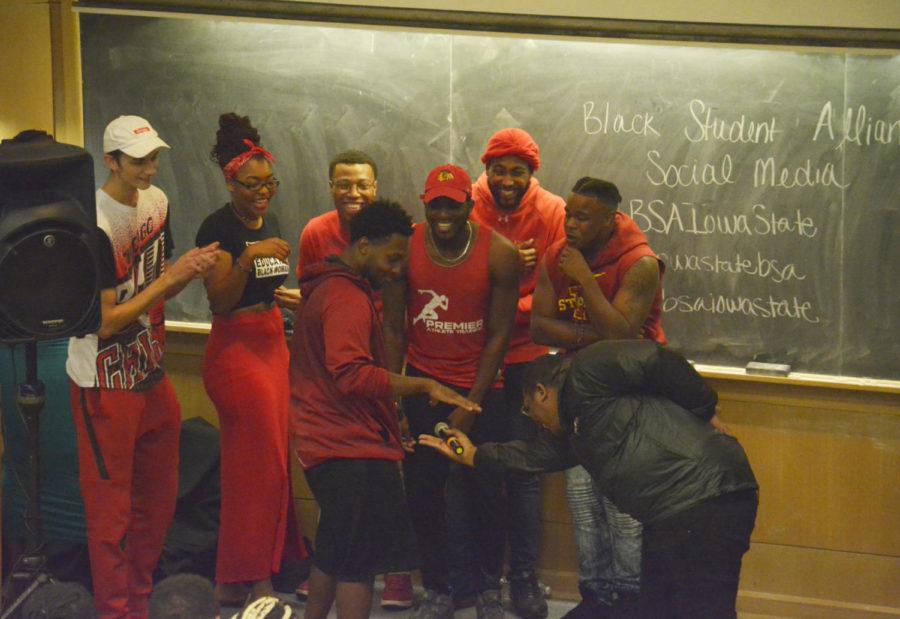 A member of the black team hands off the microphone to the red team after dissing their members during Wild n Out, a comedy and rap battle, adapted from the popular MTV show Wild n Out hosted by Nick Cannon. The rap battles, hosted by the Black Student Alliance, took place in Coover Hall on Aug. 29.