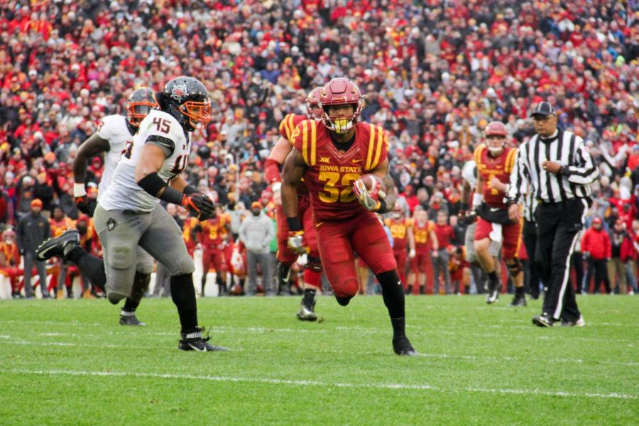 Running back David Montgomery dodges while making his way into the end zone during a game against Oklahoma State University on Nov. 11. at Jack Trice Stadium.