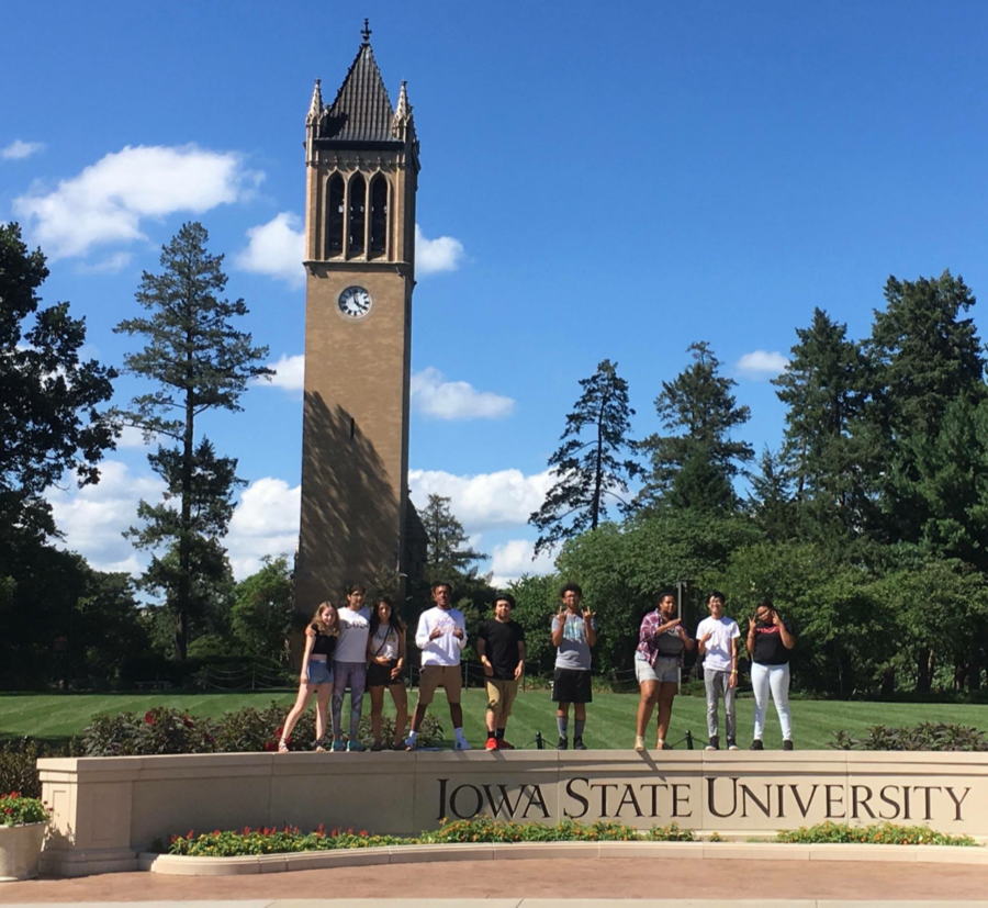 Students stand in front of the campanile after being the first students to enroll at Iowa State courtesy of the ISU 4U program.