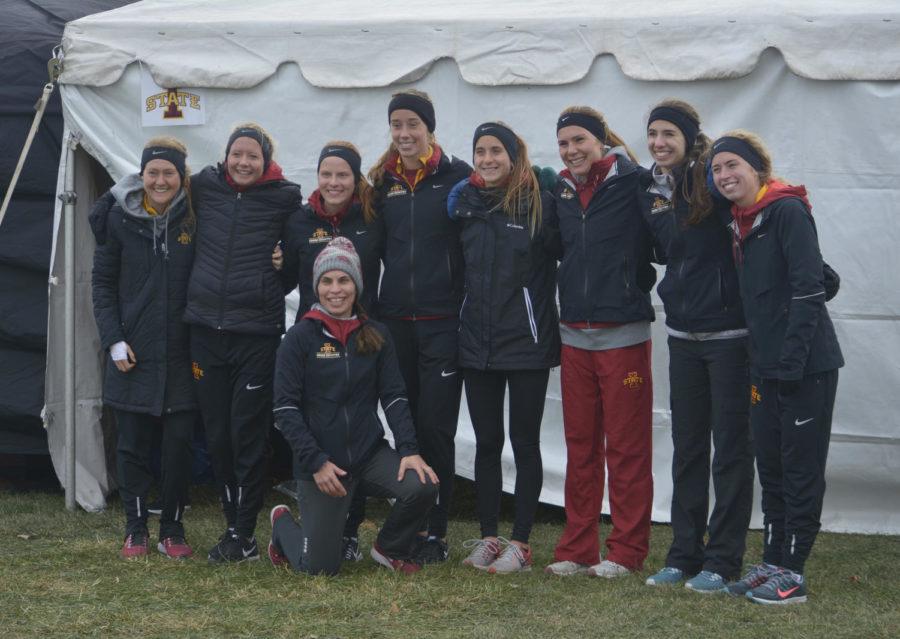 Members of the Iowa State women’s cross country team pose for photos with head coach Andrea Grove-McDonough after finishing a 6k during the NCAA Cross Country Midwest Regional held at Iowa State on Nov. 10. The women’s team scored first place with a score of 90.