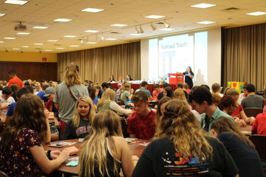 Students sit around and play bingo in hopes of winning a prize at ISU AfterDark in the Memorial Union Aug. 24.
