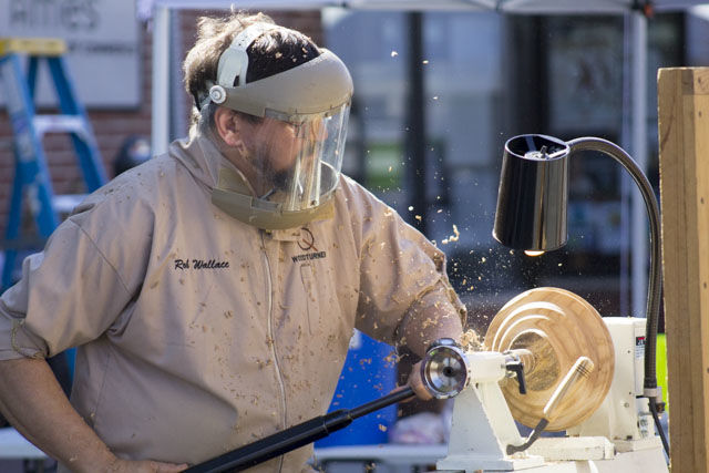 Rob Wallace gives a woodturning demonstration at the Octagon Art Festival. One hundred artists from 14 states set up their work on Main Street in downtown Ames from 10 a.m. to 4 p.m. on Sept. 23.