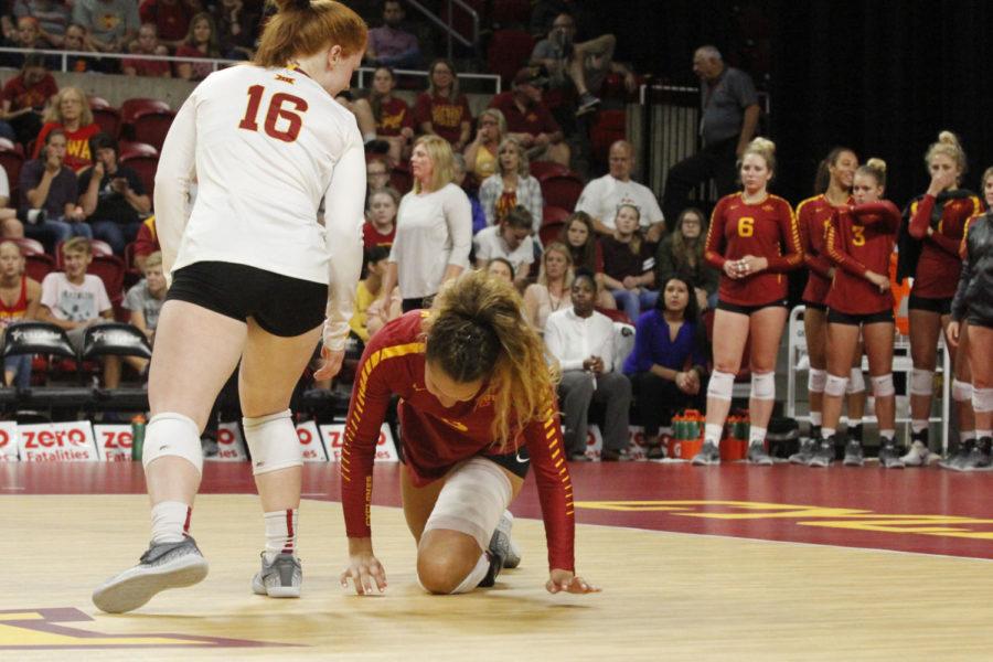 Brooke Andersen, outside hitter, falls to the ground after diving for the ball.