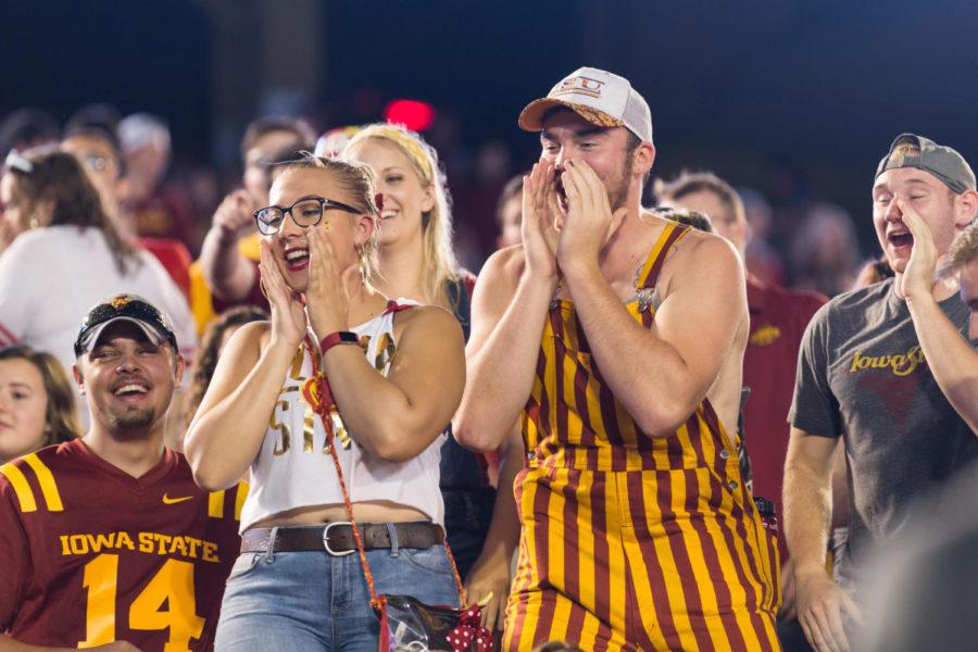 Iowa State Students keep wait out the rain delay by playing heads up seven up during the Iowa State vs South Dakota football game. 