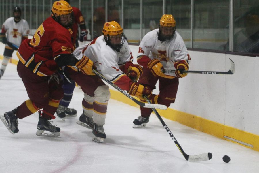 Members+of+the+Cyclone+Hockey+team+vie+for+the+puck+during+the+Cardinal+and+Gold+scrimmage+on+Sept.+14+at+the+ISU+Ice+Arena.+The+Gold+team+won+7-1.