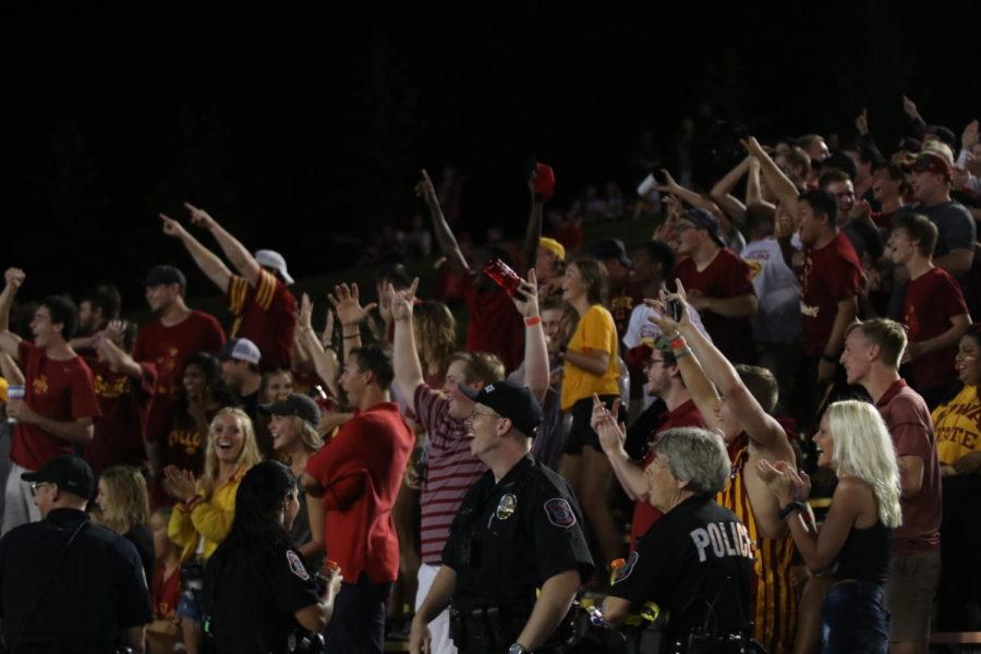 Iowa+State+students+cheer+after+someone+caught+a+frisbee+behind+their+back+during+the+rain+delay+at+the+opening+football+game+against+South+Dakota+State+on+Sept.+1.