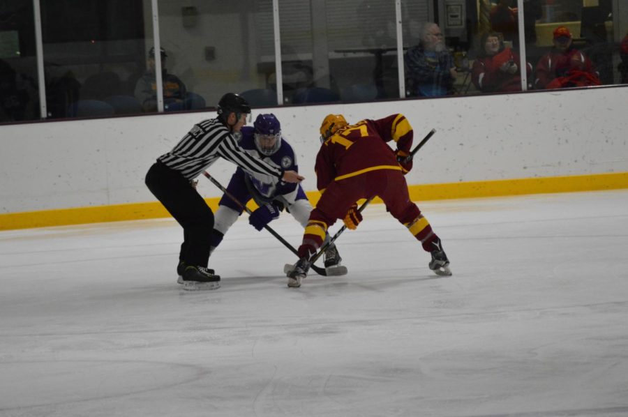 Aaron Azevedo, a Cyclone Hockey player, waits for the faceoff against a Waldorf University player. The teams played Friday night at the Ames/ISU Ice Arena. 