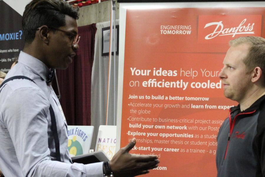 Sophmore Pre-Business major JaAmi Mock discusses career opportunities with a representative from Danfoss at the Spring Business Career Fair at Hilton Colisseum on Wednesday