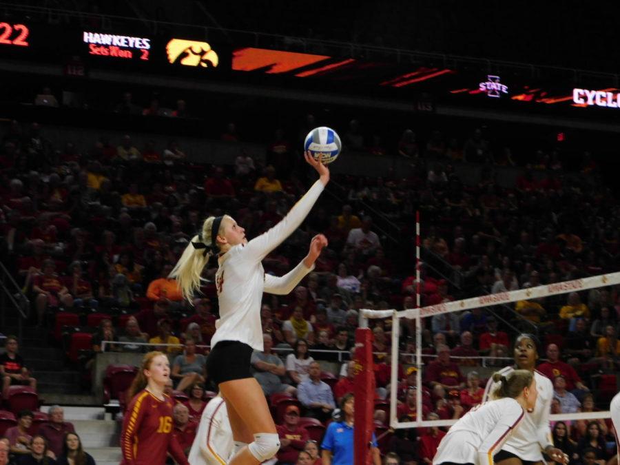 Jess Schaben, senior outside hitter, tips the ball over to the Iowa Hawkeyes during the volleyball game of the CyHawk Series on Sept. 14. The Cyclones lost the game 3-1 against the Hawkeyes.