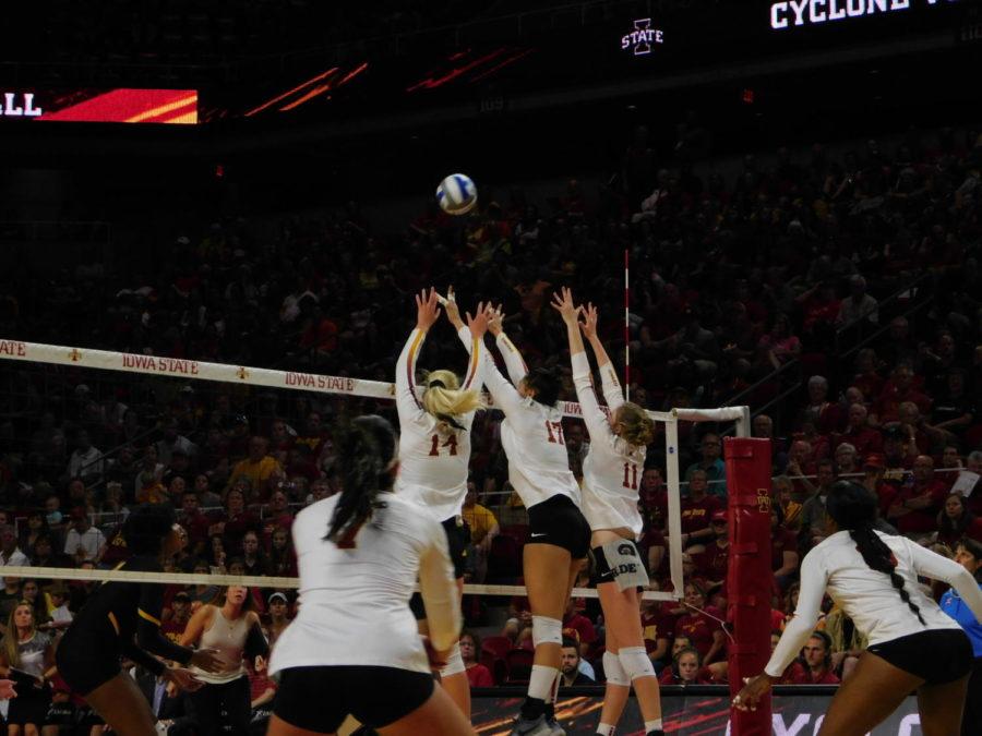 A group of Cyclones go up to defend a hit by the Hawkeyes in the volleyball game against the Iowa Hawkeyes in the annual Cy-Hawk Series on Sept. 14, 2018. After a long, well-fought battle, the Cyclones ended up losing 3-1.