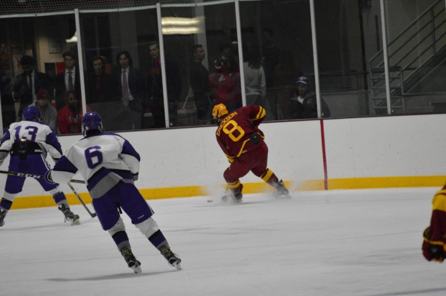 Jared Erickson, #8 an Iowa State Hockey player races to beat opponent Waldorf University to the puck at Friday nights game. The team played at the Ames ISU Ice Arena at 7:30 p.m.