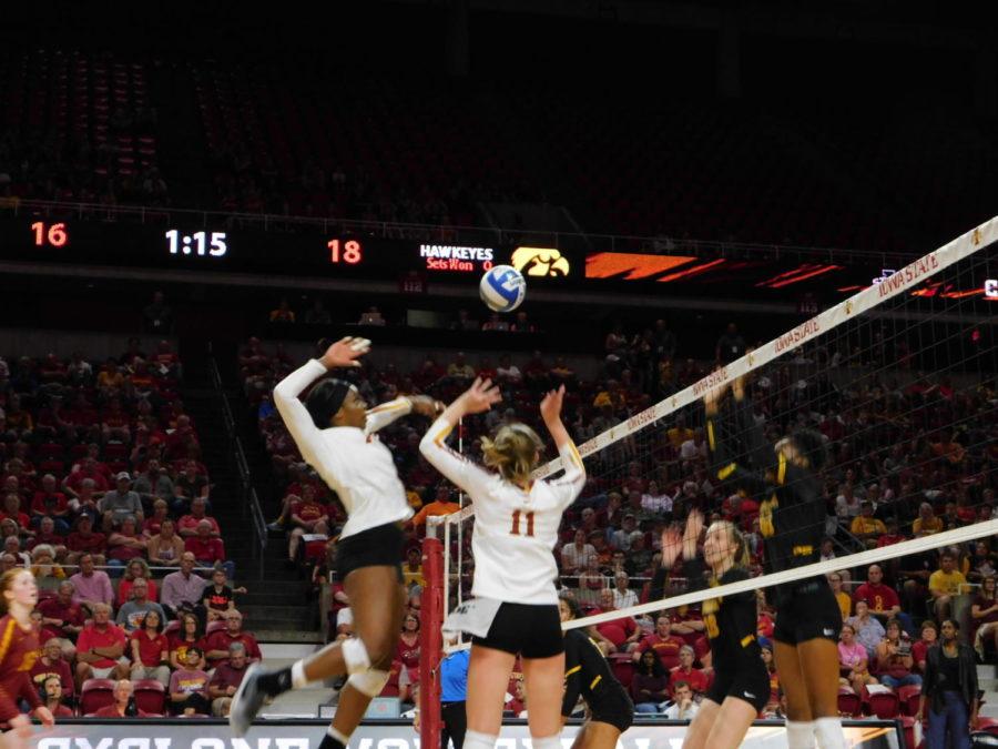 Grace Lazard, senior middle blocker, jumps up to the ball into the Hawkeyes side of the court in the CyHawk Series volleyball game on Sept. 14. The Cyclones lost 3-1 to the Iowa Hawkeyes.