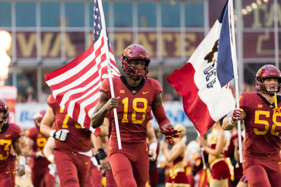 Redshirt Junior Hakeem Butler carries the United States flag into Jack Trice before the start of the Iowa State vs South Dakota Football game Sept. 1.