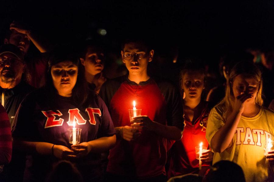 Members of the Iowa State community mourn Celia Barquín Arozamena during a candlelight vigil held in her honor on the north side of the Campanile Sept 19. 