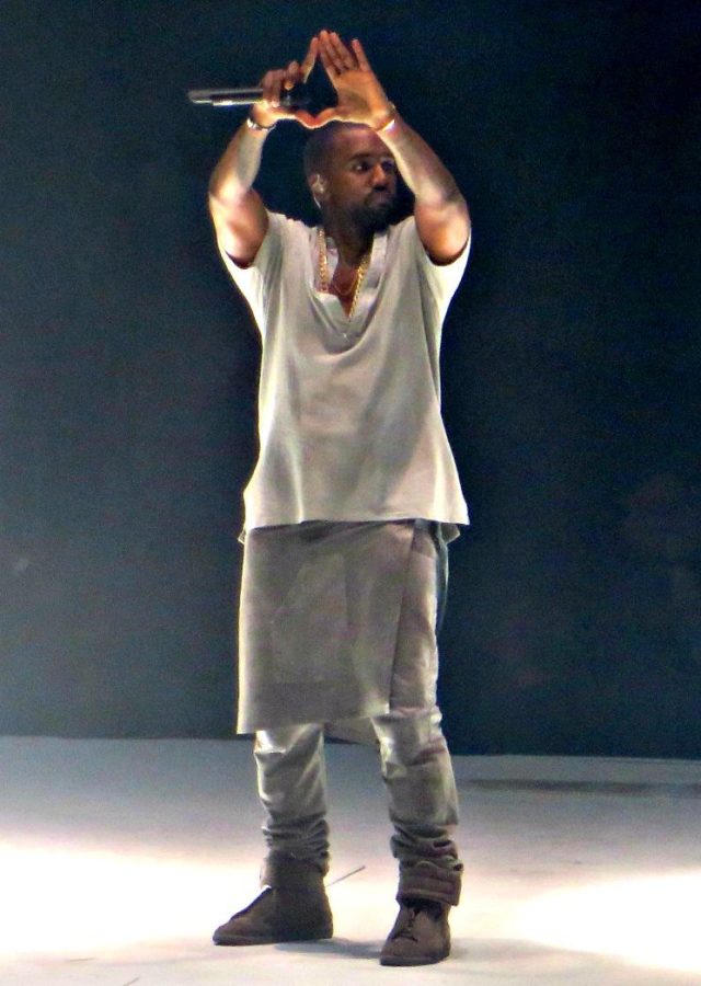 Kanye West posing at performance during the Yeezus tour.