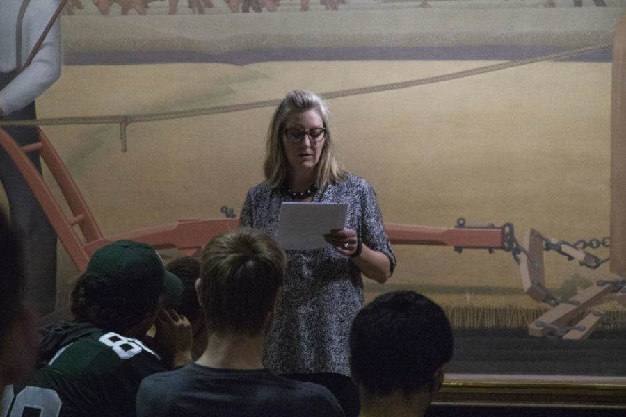 English lecturer Jennifer Knox reads aloud a short story that she wrote to an audience in the Grant Wood Foyer at the Parks library on Sep 10.