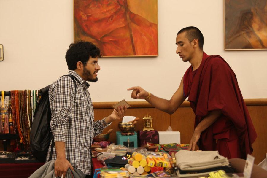 Right, Lobsang Choedak is giving information to ISU student on the Monks and their Monastery. Monday was the first day the Monks were at ISU in the Memorial Union main lounge. 