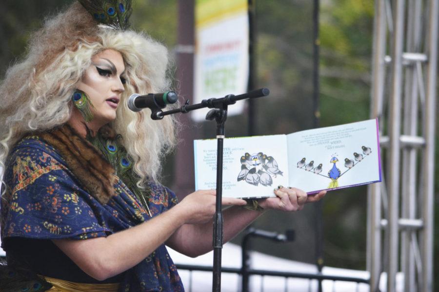 Ilana Logan reads “A Peacock Among Pigeons” by Tyler Curry during the Drag Queen Story Time at the second annual Pridefest in Ames on Sept. 29. The book follows Peter the peacock as he realizes he’s meant to stand out and not be embarrassed that he’s not like the other birds.