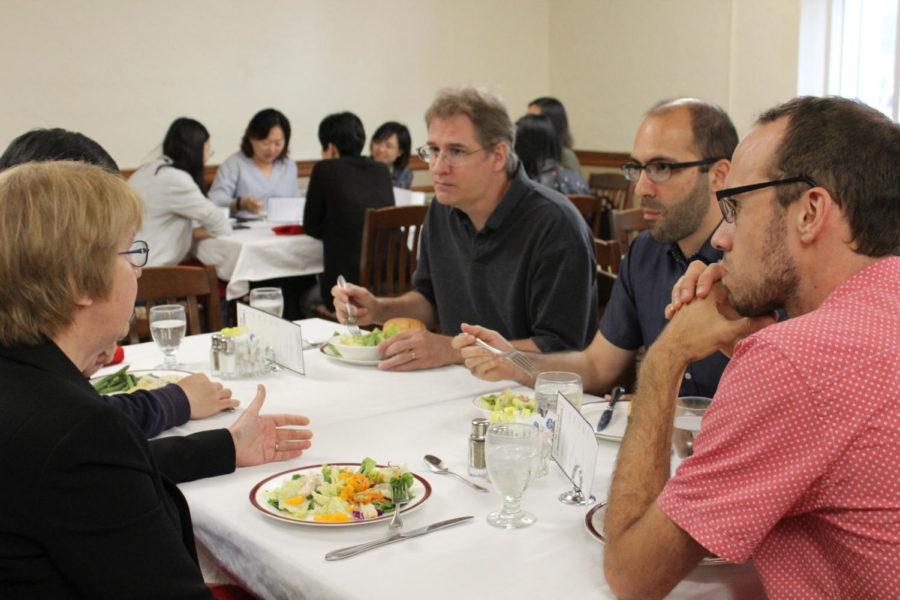 Iowa State Faculty members Brent Kreider, Borzoo Bonakarpour, and Claus Kadelka engage in conversation with Dean Beate Schmittmann over lunch at the Joan Bice Underwood Tearoom in MacKay Hall on Sept. 19