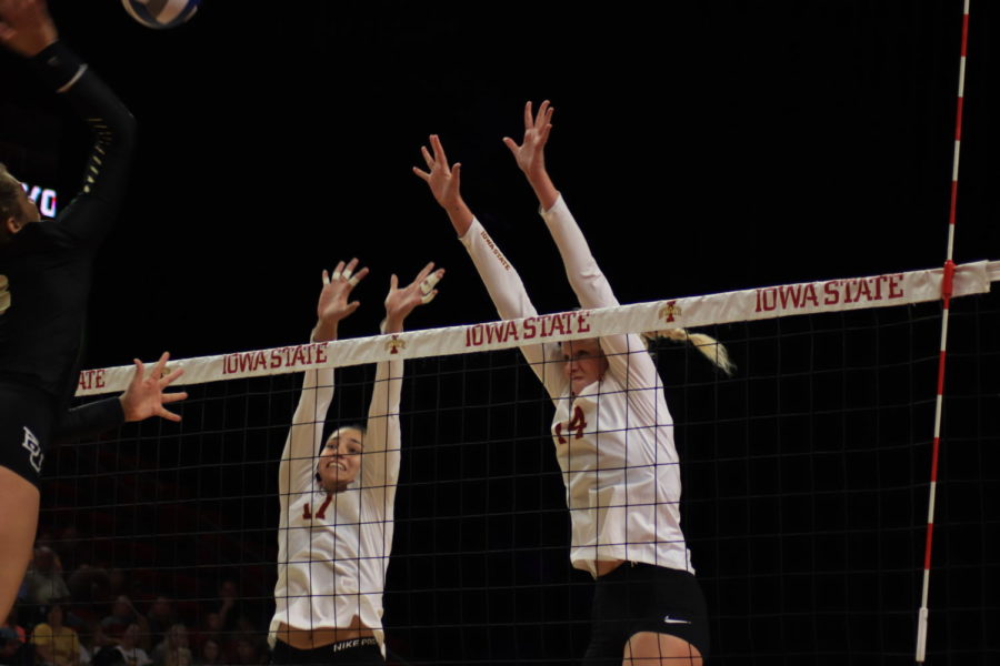 Sophomore Candelaria Herrera (left) and senior Jess Schaben (right), work together to block the incoming ball against Baylor in Hilton Coliseum on Sept. 22. The Cyclones lost 2-3. 