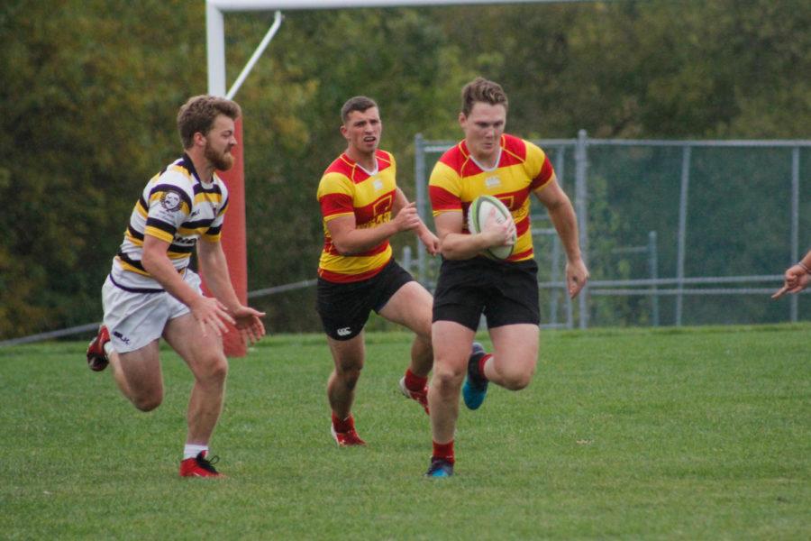 An ISU mens rugby player prints past a player from the University of Missouri during their match against the Mizzou Tigers on Sept. 29 at ISUs southwest athletic complex. Iowa State won 24-0.