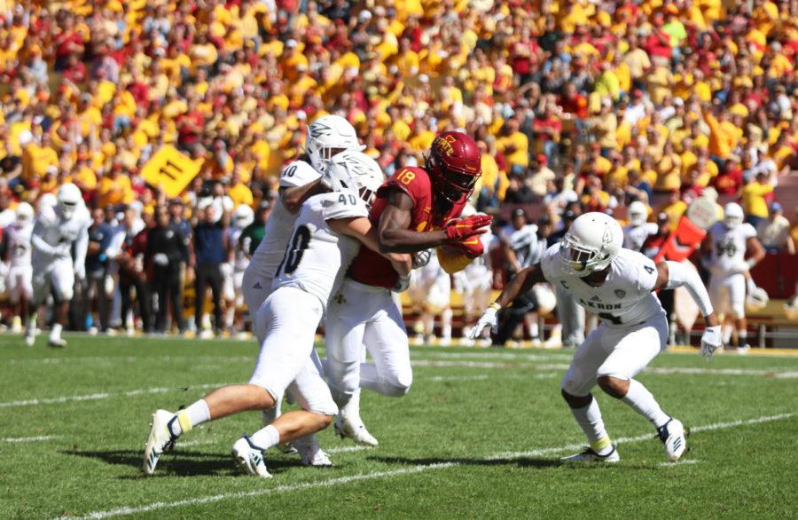 Wide+receiver%2C+Hakeem+Butler%2C+tries+to+escape+the+grasp+of+University+of+Akron+players+during+their+football+game+at+Jack+Trice+Stadium+on+Sept.+22.+The+Cyclones+won+26-13.