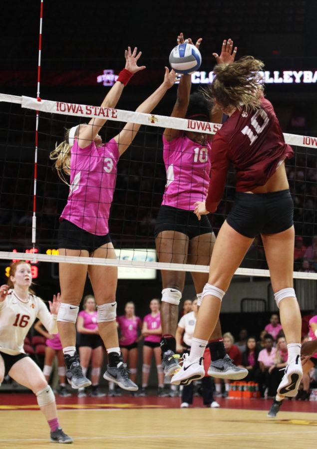 Setter Jenna Brandt (left) and middle blocker Grace Lazard (right) attempt to block a ball from University of Oklahoma players during the volleyball game Oct. 3 at Hilton Coliseum. The Cyclones lost 3-1.