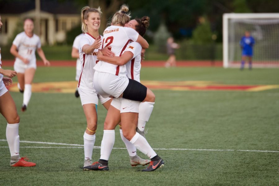 Redshirt Junior Kasey Opfer hugs her teammate after the Cyclones scored the first goal of the Iowa Corn Cy-Hawk Series game. 