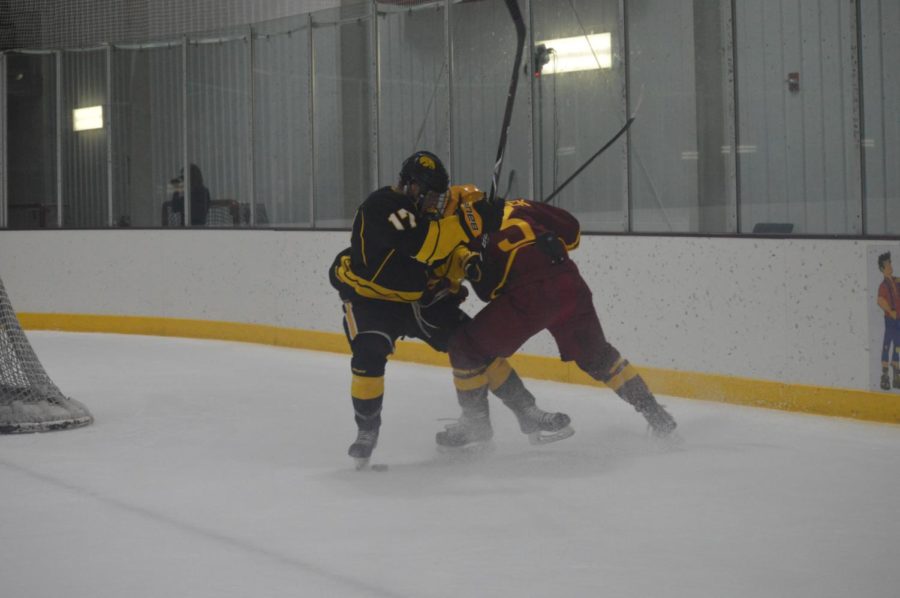 Cyclone hockey player Jeremy Szczurek defends the puck at Fridays game against the University of Iowa. The game was held at the Ames/ISU Ice Arena at 7:15 p.m.
