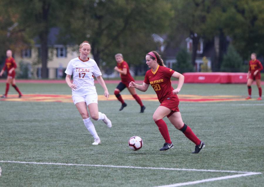 Then-junior+midfielder+Kassi+Ginther+tries+to+keep+the+ball+out+of+reach+from+University+of+Texas+player+Amber+Stearns+during+their+game+at+the+Cyclone+Sports+Complex+on+Oct.+5%2C+2018.+The+Cyclones+lost+2-1+after+playing+the+first+half+in+the+rain.