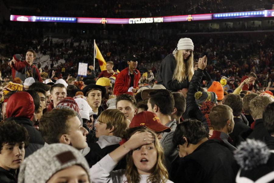 Iowa State fans storm the field after the Cyclones defeat West Virginia 30-14.
