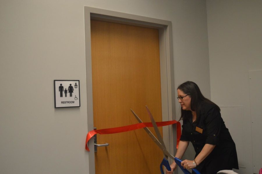 Assistant dean of inclusion and diversity Susan Vega Garcia cuts the ribbon to the new gender inclusive restroom in Park Library.The ribbon cutting took place on Wednesday Oct. 31, in Parks Library in front of the first floor restrooms. 