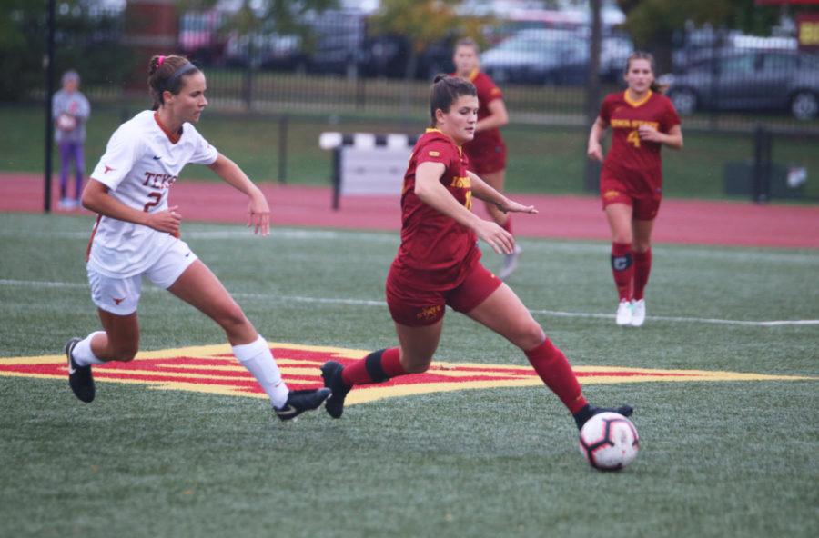 Forward Klasey Medelberg tries to keep the ball out of reach from a University of Texas player during their game at the Cyclone Sports Complex on Oct. 5. The Cyclone lost 2-1 after playing the first half in the rain.