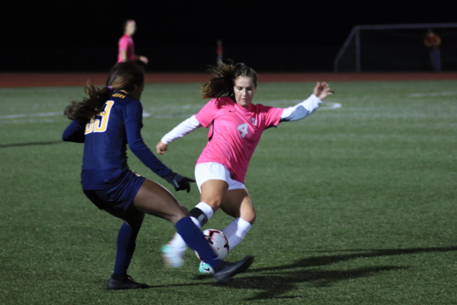 Senior Emily Steil steals the ball away from West Virginia on Oct. 12 at the Cyclone Sports Complex. The cyclones are wearing pink to support breast cancer awareness.