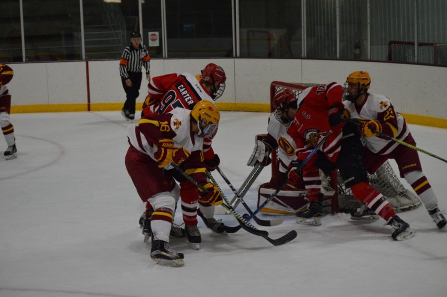 Cyclone Hockey defends against Minot State as they try to make a goal at Friday nights game. The game was held at the Ames/ISU Ice Arena. ISU won the game against Minot State with a final score of 3-1. 