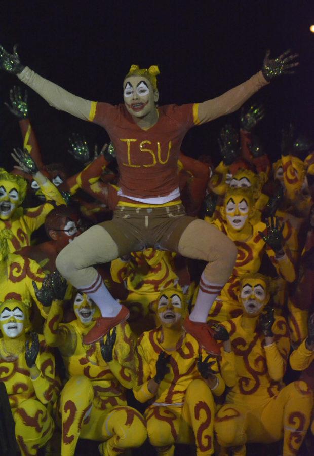 A skit titled “CY Chasers” is performed during the finals of Yell Like Hell on Oct. 27 during the Homecoming Pep Rally outside the Alumni Center. The finals of Yell Like Hell featured students covered in cardinal and gold paint from head to toe. The groups performed skits full of chants and dancing.