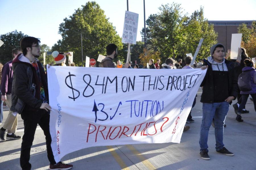 The Iowa Student Action Group protest tuition and student debt with chants and signs on campus Oct. 15. 