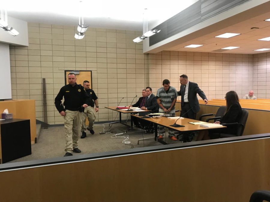 Collin Richards, who is charged with first-degree murder, is led to his seat by attorney Paul Rounds before his first court appearance. Judge Bethany Currie ruled there will be an open trial.