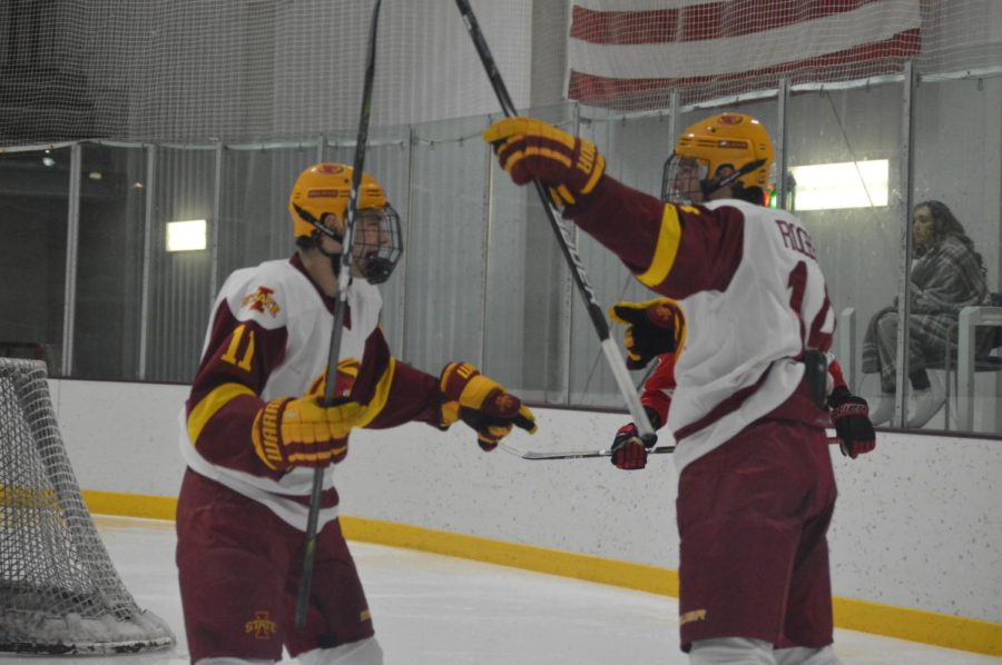 Nick Rogers, #14, and Hunter Dolan, #11, on the Cyclone hockey team celebrate after a goal at Friday nights game. The game was held at the Ames/ ISU Ice Arena. The Cyclones won the game against Minot State with a final score of 3-1. 