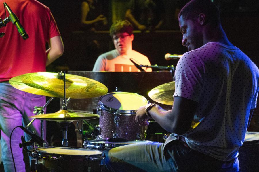 Senior Daniel Ansong drums out the beat as he helps to open the act for at the M-shop on Sep 12.