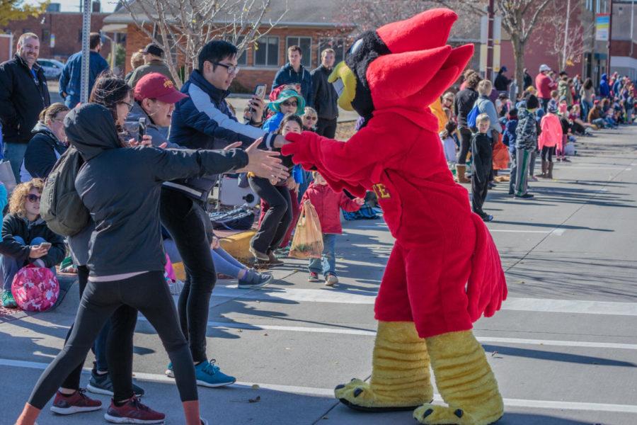 Cy the Cardinal high-fives Iowa State fans at the 2018 ISU Homecoming Parade in Downtown Ames on Oct. 21.
