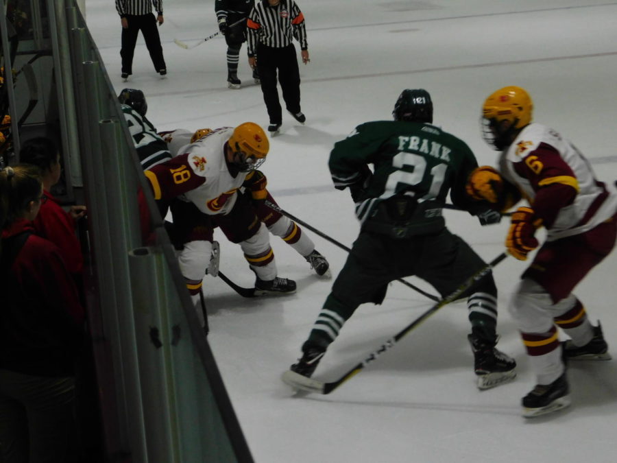 A pile up near the Cyclones bench to fight for the puck to keep possession during the game against the Ohio Bobcats at the Ames/ISU Ice Arena on Oct. 19. The Cyclones ended the game with a 4-1 loss after fighting all game.