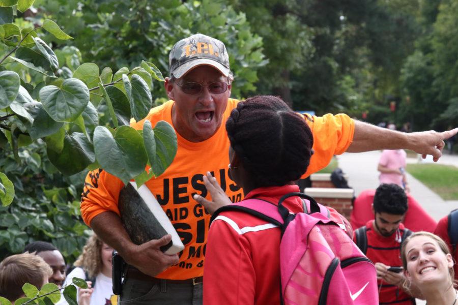 Matt Bourgault, a traveling preacher, argues with a student about religious beliefs at the Agora outside Parks Library on Wednesday afternoon.