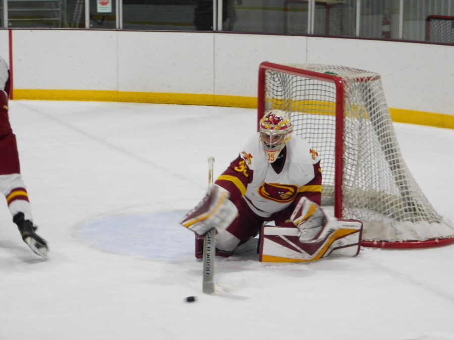 Matt Goedeke, senior goaltender, reaches for the puck after a save against the Ohio University Bobcats during the game at the Ames/ISU Ice Arena on Oct. 19, 2018. The Cyclones suffered a tough 4-1 loss to the Bobcats.