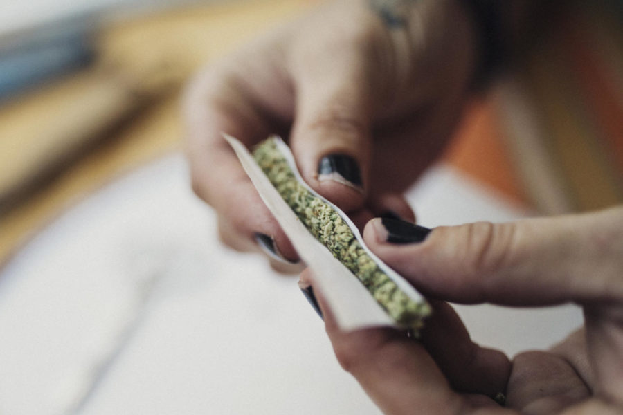 Hands of a 40 year old woman rolling a joint, prescribed by a doctor for her chronic illness.