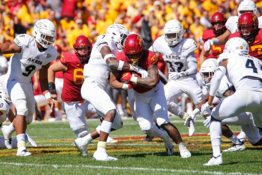 Running back David Montgomery pushes past players from the University of Akron during the game against the Zips on Sept. 22 at Jack Trice Stadium. The Cyclones won 26-13.