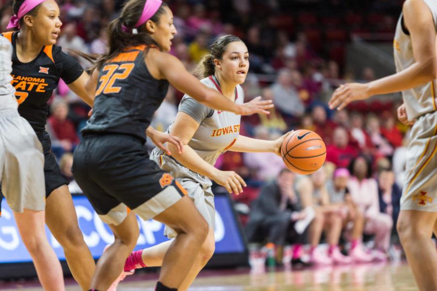 Freshman Guard Rae Johnson dribbles around players during the Iowa State vs OSU basketball game Feb. 10 in Hilton Coliseum.The cyclones were narrowly defeated by the Cowgirls 73-81