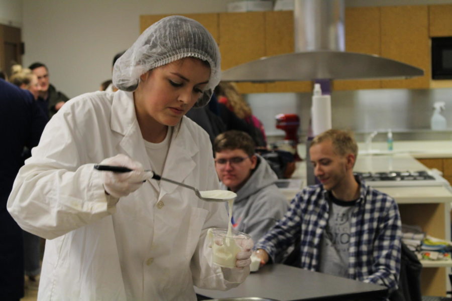 Kayla Johnson, food science major, scoops freshly-made liquid nitrogen ice cream into a cup for people to try. The event was held by the Food Science Club on Oct. 11 in MacKay Hall for Human Sciences Week.