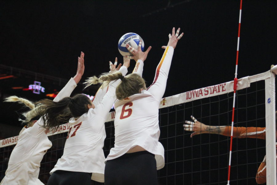 Senior Jess Schaben (left), sophomore Candelaria Herrera (middle), and Freshman Eleanor Holtaus (right) go to block the ball at the Iowa State vs. Texas volleyball game at the Hilton Coliseum on Oct. 24. The Cyclones fell to the Longhorns in three sets.